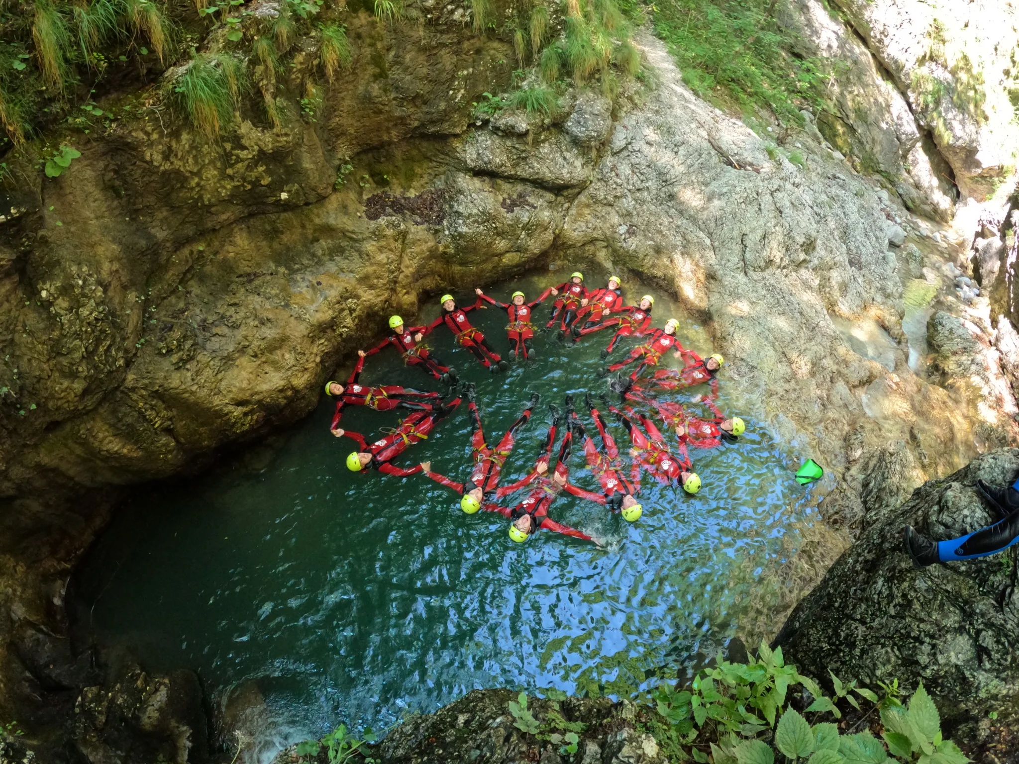 Group enjoying a natural pool during a canyoning adventure in Sušec Canyon
