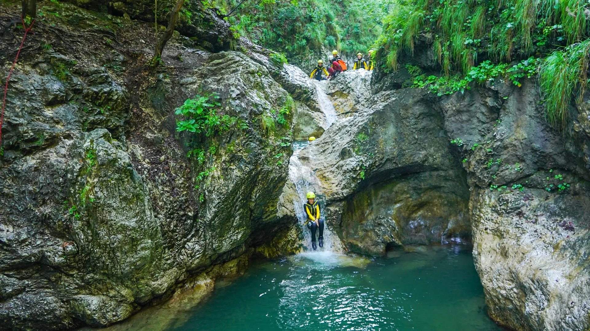 Canyoning in Sušec Gorge with a natural rock slide into a clear pool