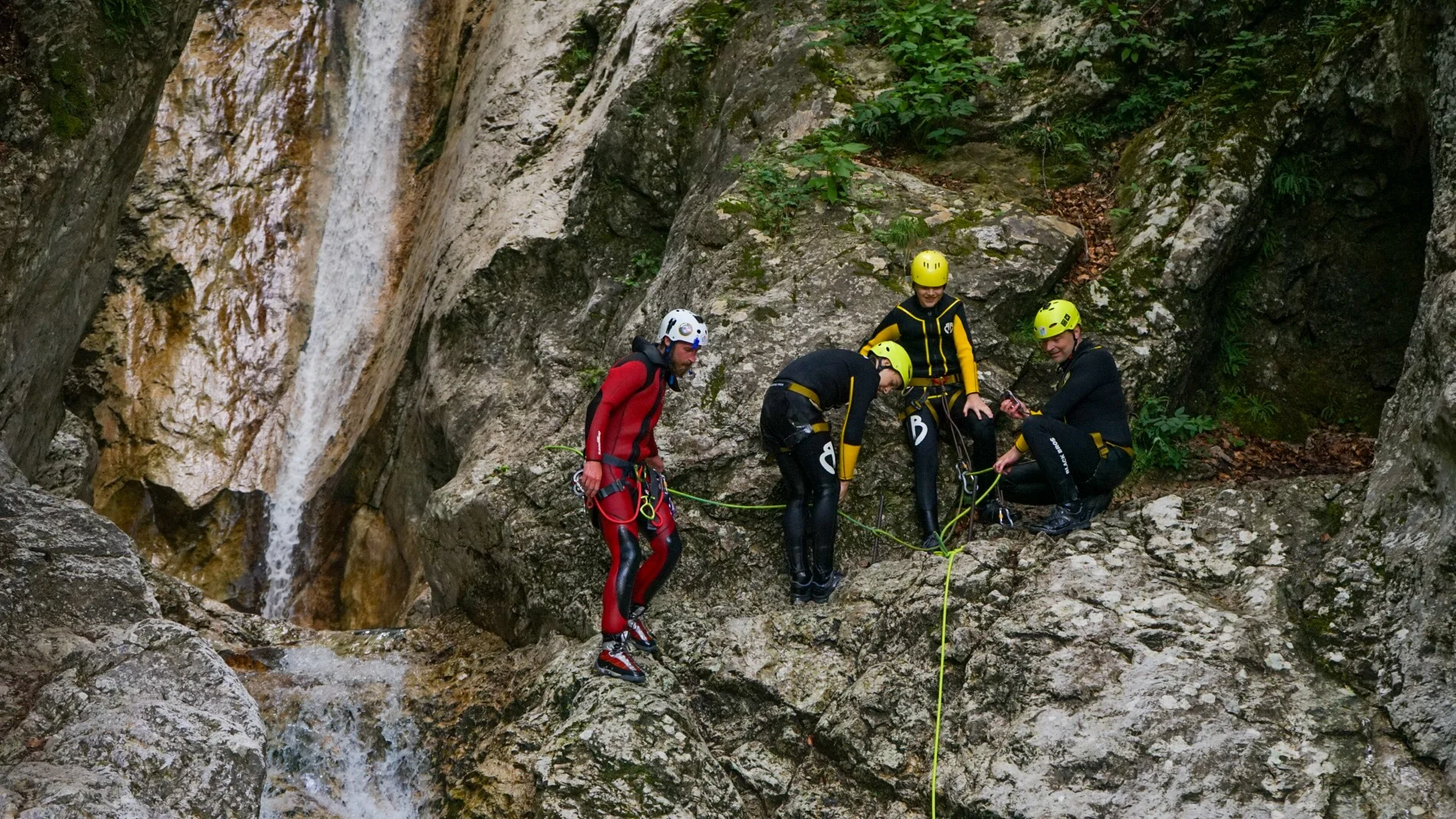Canyoning guide preparing participants for a rope descent in Sušec Canyon