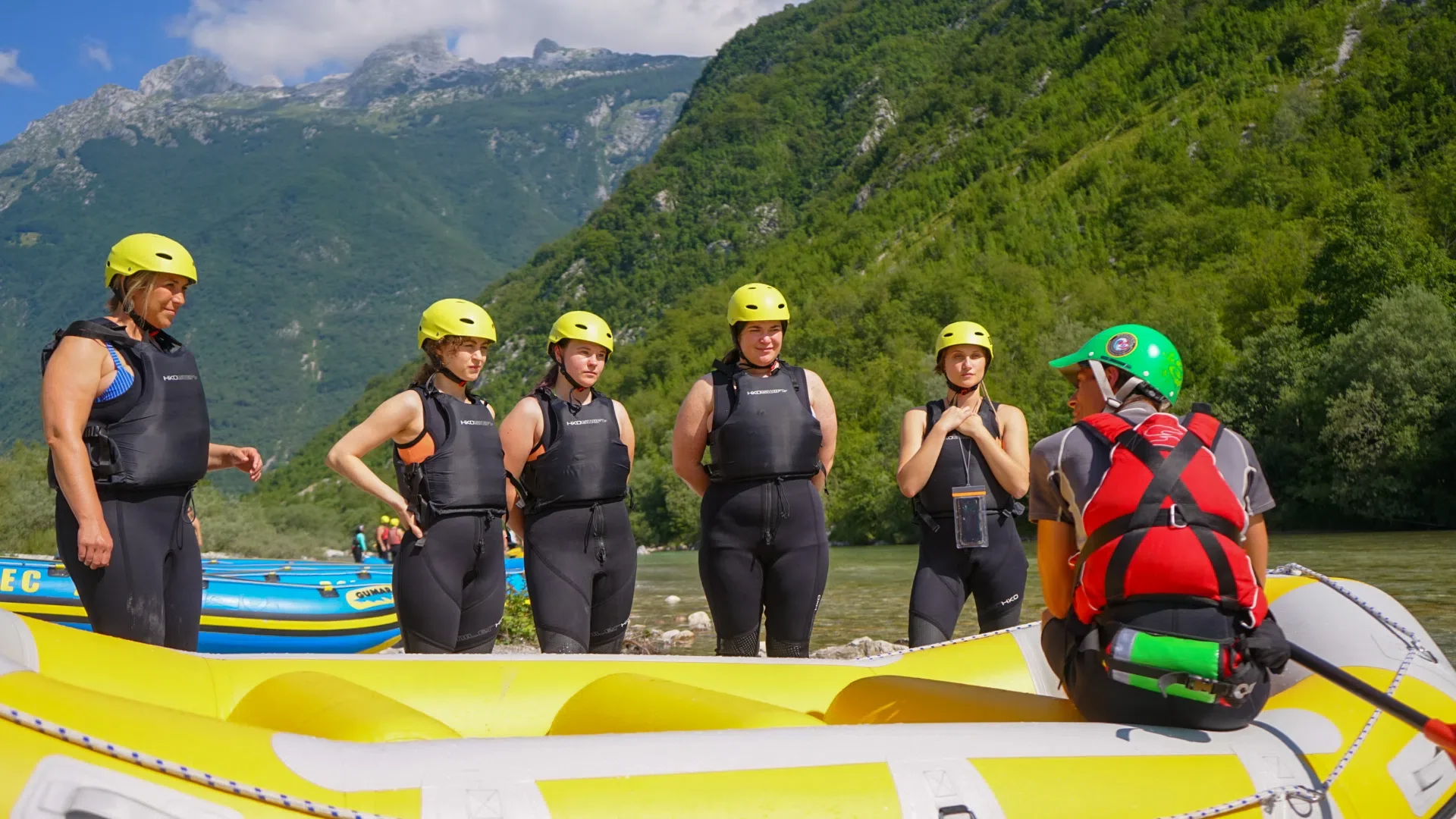 Rafting group with a local guide preparing for a trip on the Soča River.