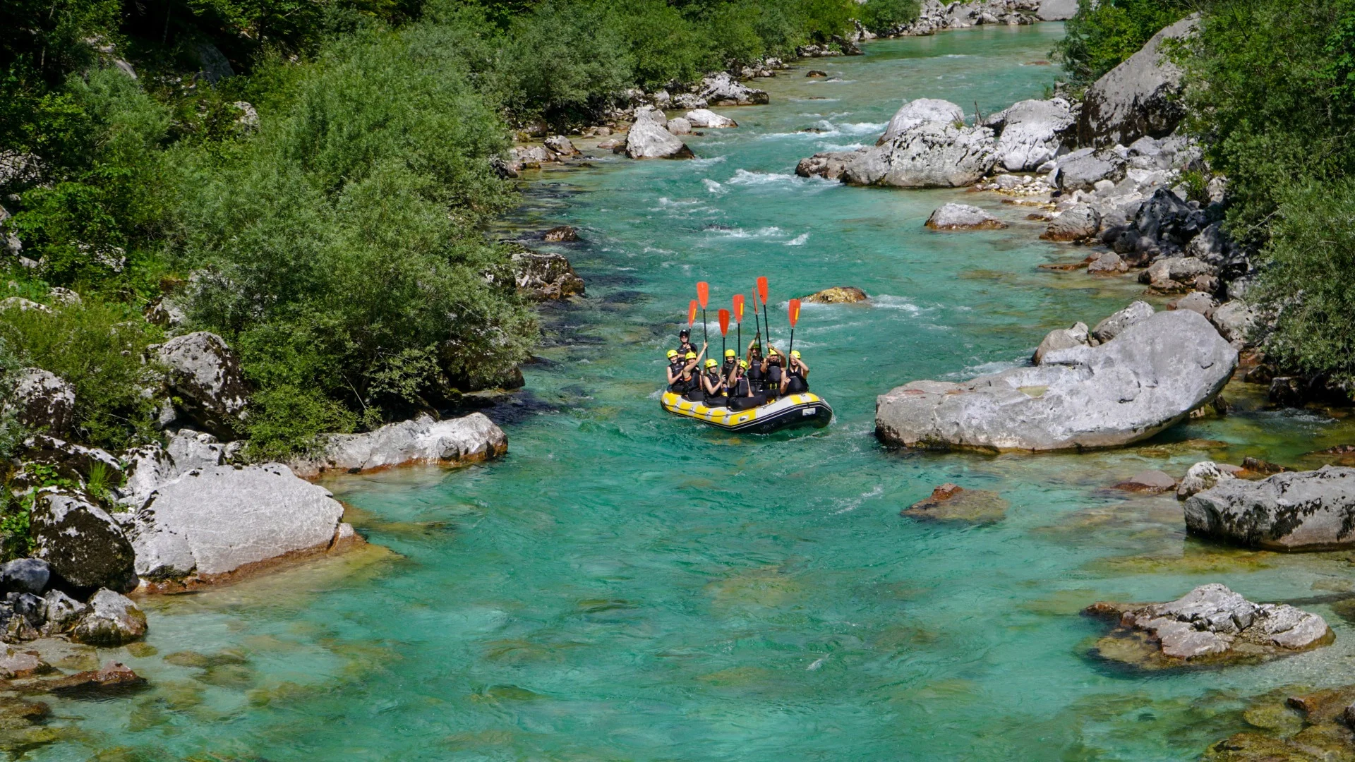 Rafting group paddling on the turquoise Soča River in Slovenia