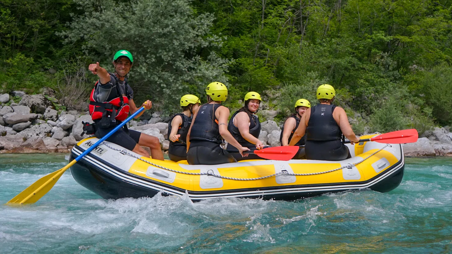 Rafting boat seen downstream in the clear Soča River