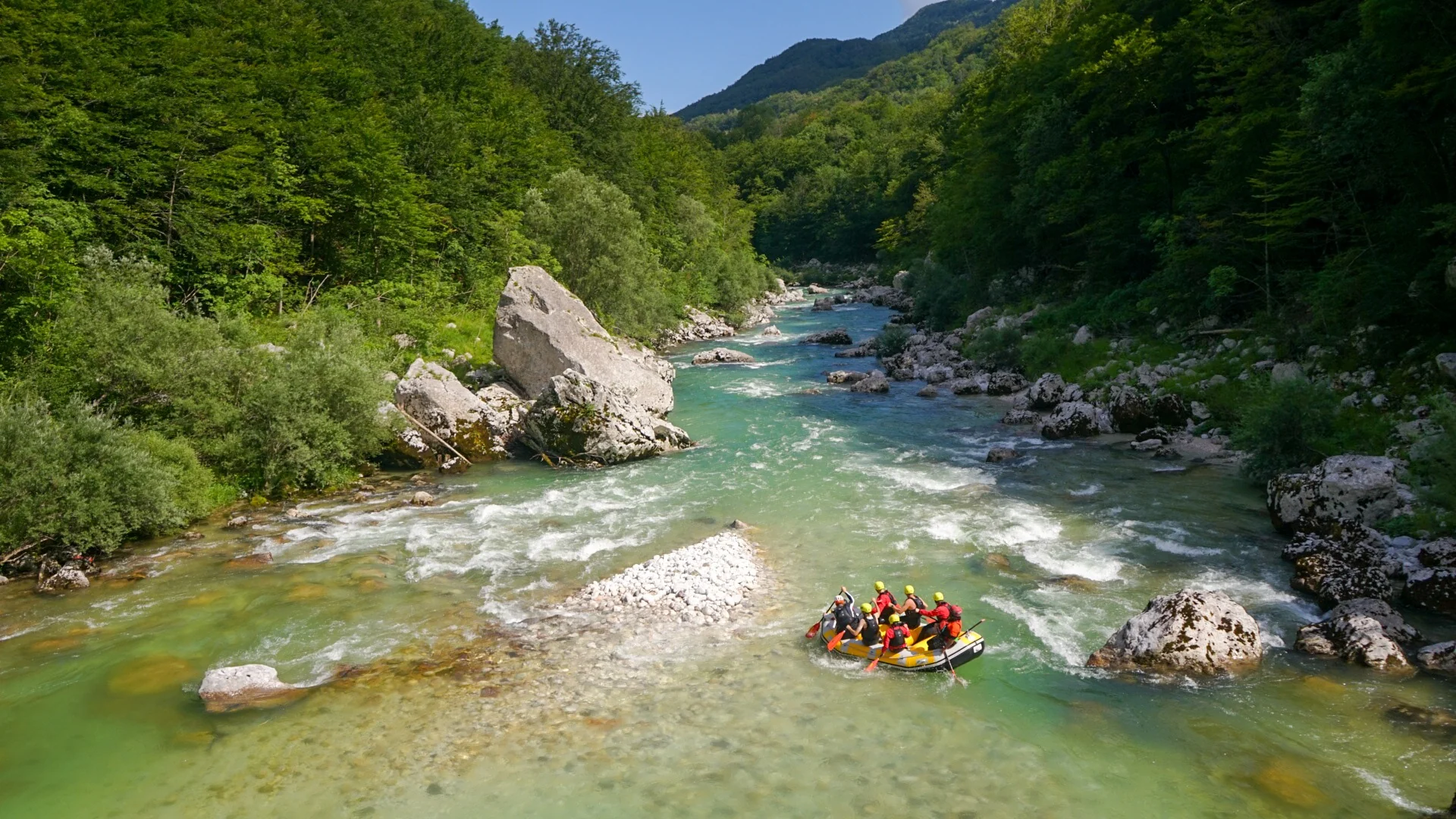 Rafting group travelling through a scenic mountain section