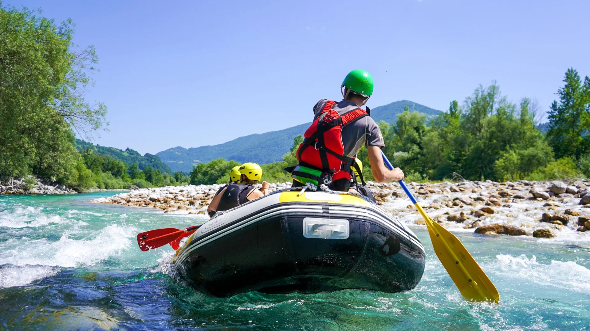 Relaxed family rafting adventure on the turquoise Soča River near Kobarid